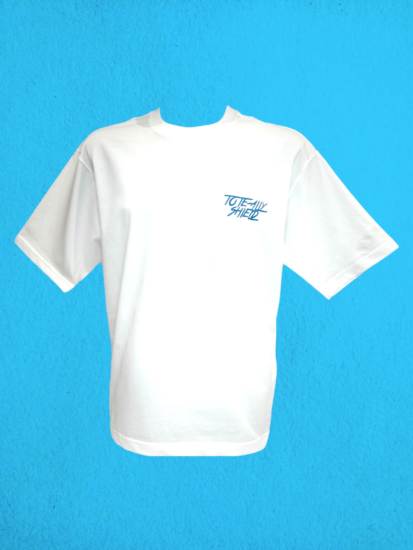 Front view of white short-sleeved, boxy-fit, heavyweight T-shirt. The design is plain with the ‘TOTE-ALLY SHIELD’ logo on the left chest in baby blue text.